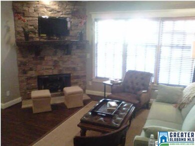 Rock fireplace with cedar mantle in den - gas fire