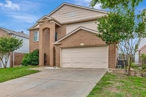 Traditional-style house with concrete driveway and a garage