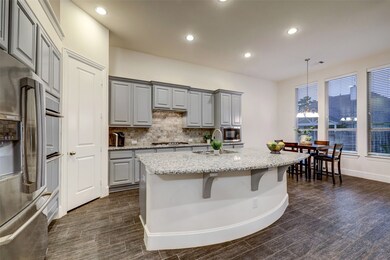 Kitchen boasts Kent Moore custom cabinets featuring soft close drawers, custom pullouts, pots and pan drawer, and more!