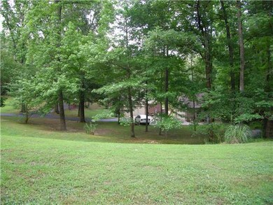The home sits away from the road near the middle o