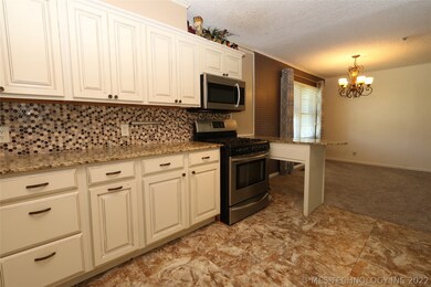 Kitchen leading to open living and dining.