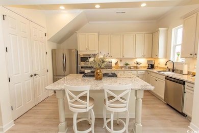 Kitchen with light wood-style flooring, a kitchen 