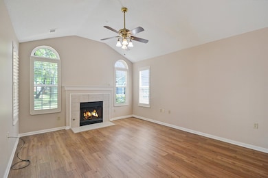 Great room has a vaulted ceiling: windows with plantation shutters. Look at that natural light!