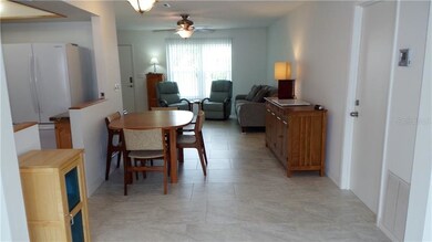 Formal dining area in foreground, kitchen to the l