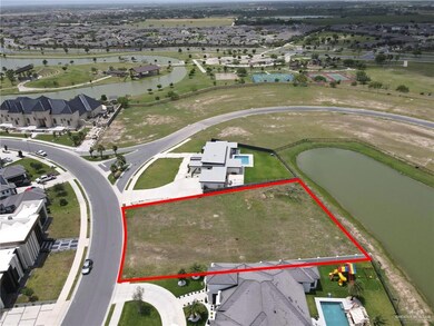 Aerial perspective of suburban area with property parcel outlined and a large body of water
