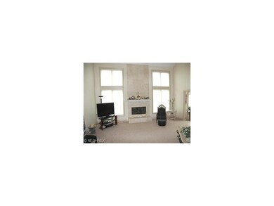 The vaulted two story great room features a traver
