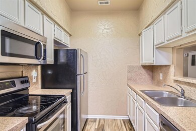 Kitchen featuring appliances with stainless steel