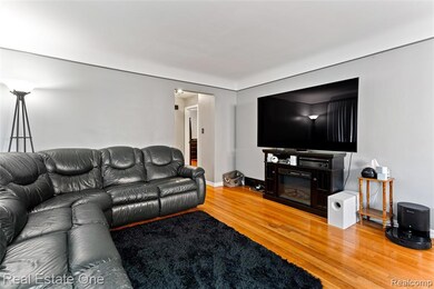 Living area with light wood-style flooring and baseboards