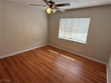 Empty room featuring light wood finished floors, b