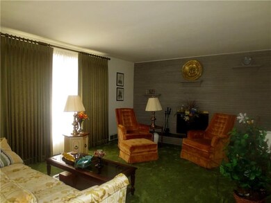 The living room boasts a large picture window to a