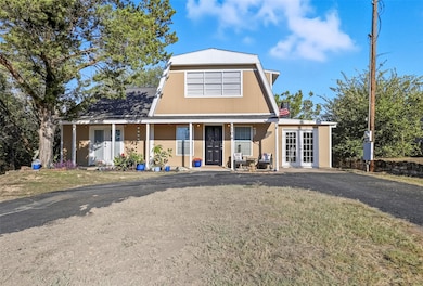 View of front of property featuring a front yard and a porch