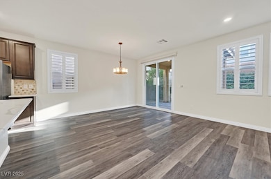 Unfurnished dining area featuring dark wood-style