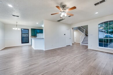 Unfurnished living room featuring light wood-style floors, a textured ceiling, stairway, recessed lighting, and a ceiling fan