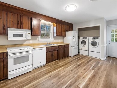Kitchen w/ White Appliances, Disposal, Updated Luxury Vinyl Flooring, Laundry Closet & Side/Rear Exit