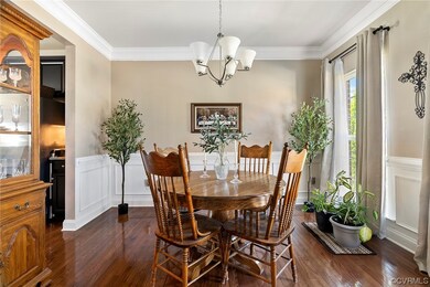 Wood floored dining area featuring a notable chand