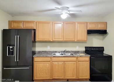 Kitchen with black appliances, under cabinet range