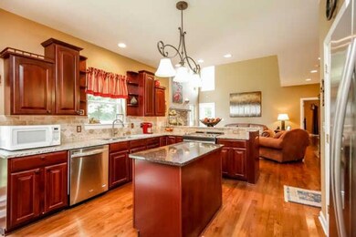 Stunning kitchen including new granite countertops and island, new stainless appliances and cherry cabinetry. Also has counter seating for your guests while you cook and entertain.