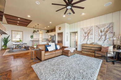 Living area featuring a ceiling fan and recessed 