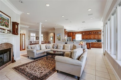 LIVING ROOM WITH GAS FIREPLACE OPENS TO KITCHEN