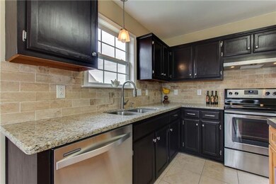 The kitchen has been updated with new lighting, tumbled marble back splash and hardware!