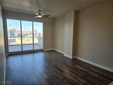 Spare room featuring dark wood-type flooring, ceil