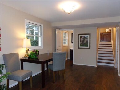 From the carport , one enters into the den/family room.  What great open space for a desk area and inviting tv room.  There is a half bath nearby in this space,....along with a washroom where there are cabinets to fold clothes on.  