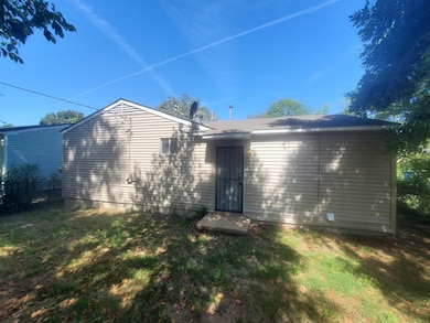 Back of property with a yard