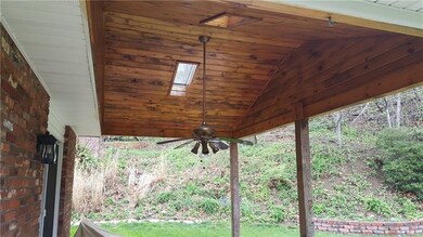 Cedar ceiling in patio roof with skylights and fan