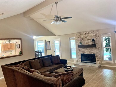 High Vaulted Ceiling in Living Room with Gorgeous Stone Surround Fireplace