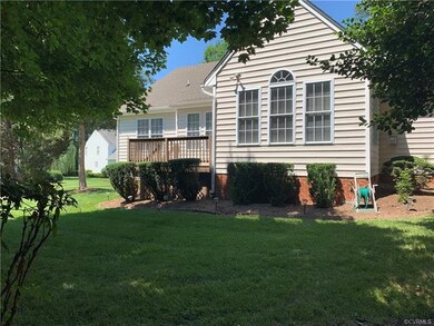 Heavily treed backyard looking back towards deck a