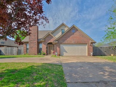 Traditional-style home with concrete driveway, brick siding, a chimney, and a garage