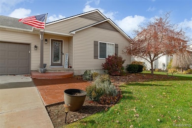 View of front of home featuring a front yard and an attached garage