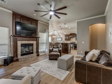 Living room with ornamental molding, light wood-ty
