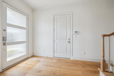 LIGHT-FILLED FOYER WITH STAIRWAY LEADING TO UPPER