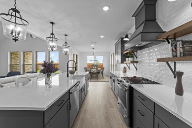 Kitchen with full-height tile backsplash & floating shelves