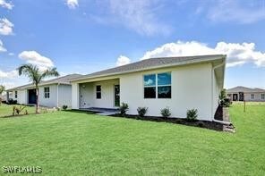 Back of home with covered lanai to the left