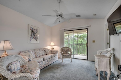 Living room with lofted ceiling, carpet flooring, 
