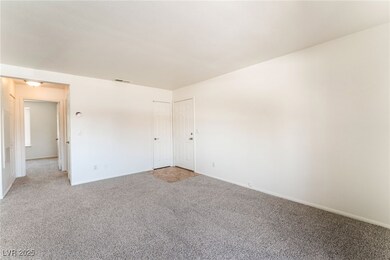 Unfurnished room featuring baseboards, visible ven