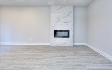 Unfurnished living room with wood finished floors and a premium fireplace