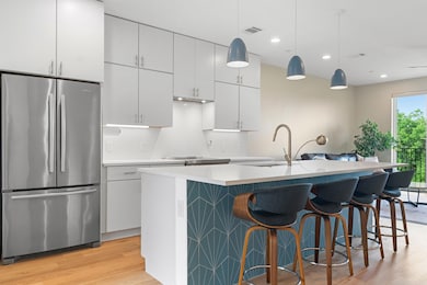Kitchen featuring light countertops, a sink, free