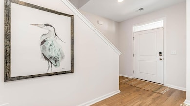 Foyer entrance with baseboards, light wood-type flooring, recessed lighting, and stairs