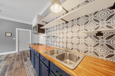 This kitchen features modern open shelving, a styl