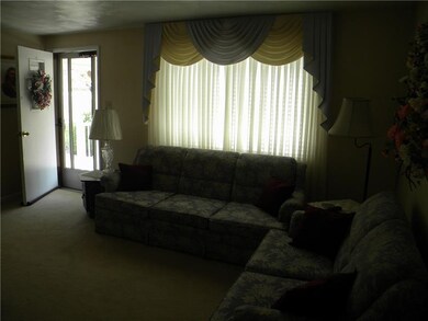 Nice size living room with hardwood floors under c