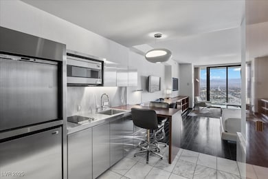 Kitchen featuring stainless steel appliances, a si