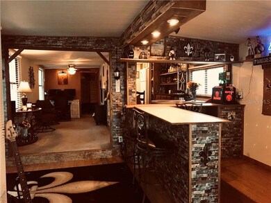 Florida room has a built in bar with recessed lighting.