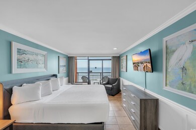 Bedroom with crown molding, light tile patterned floors, and access to exterior