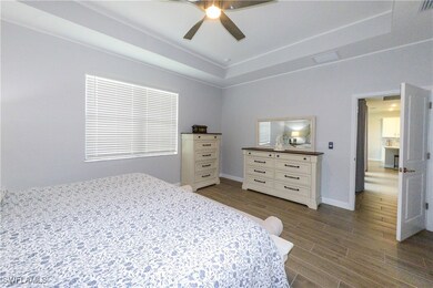 Bedroom featuring a ceiling fan, wood tiled floor,