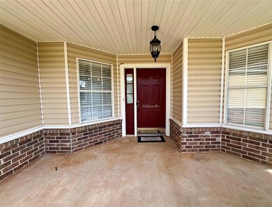 View of exterior entry featuring covered porch