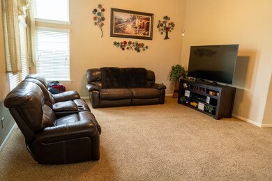 Living room is open concept to the dining and kitchen areas.