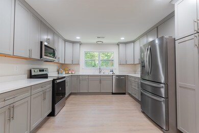 Kitchen featuring gray soft close cabinets, sink, 